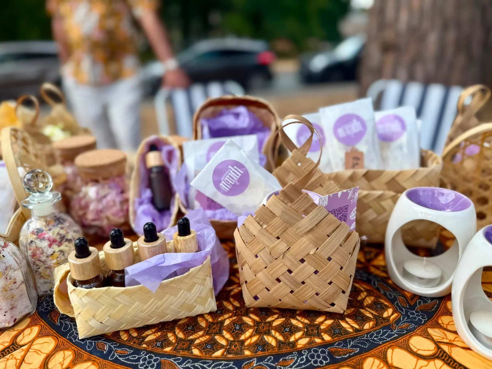 Mandi7 products on the batik cloth: besek baskets, oils, bath salts and burners