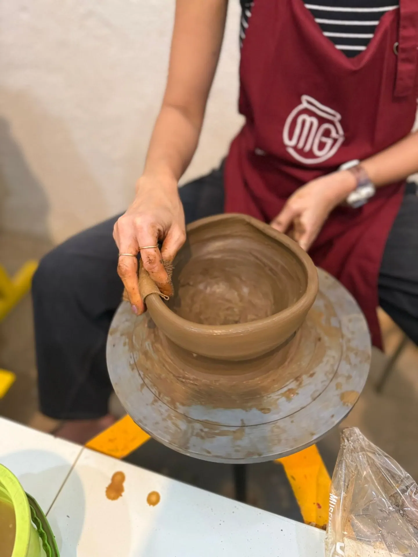 Shaping clay on the pottery wheel